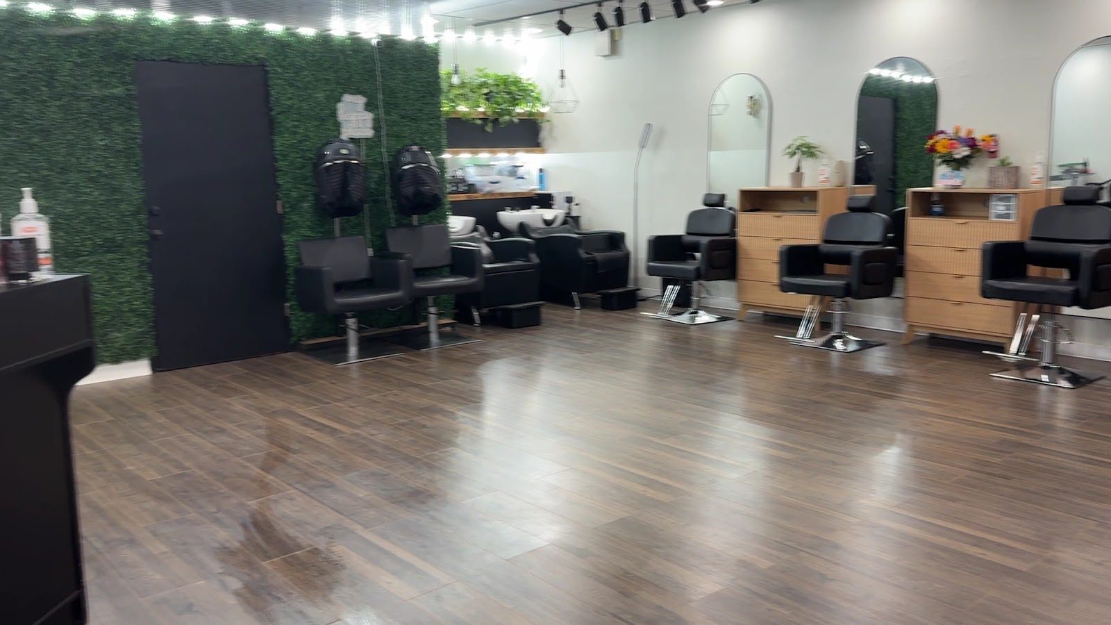 Shampoo chairs and mirror stations along the salon wall